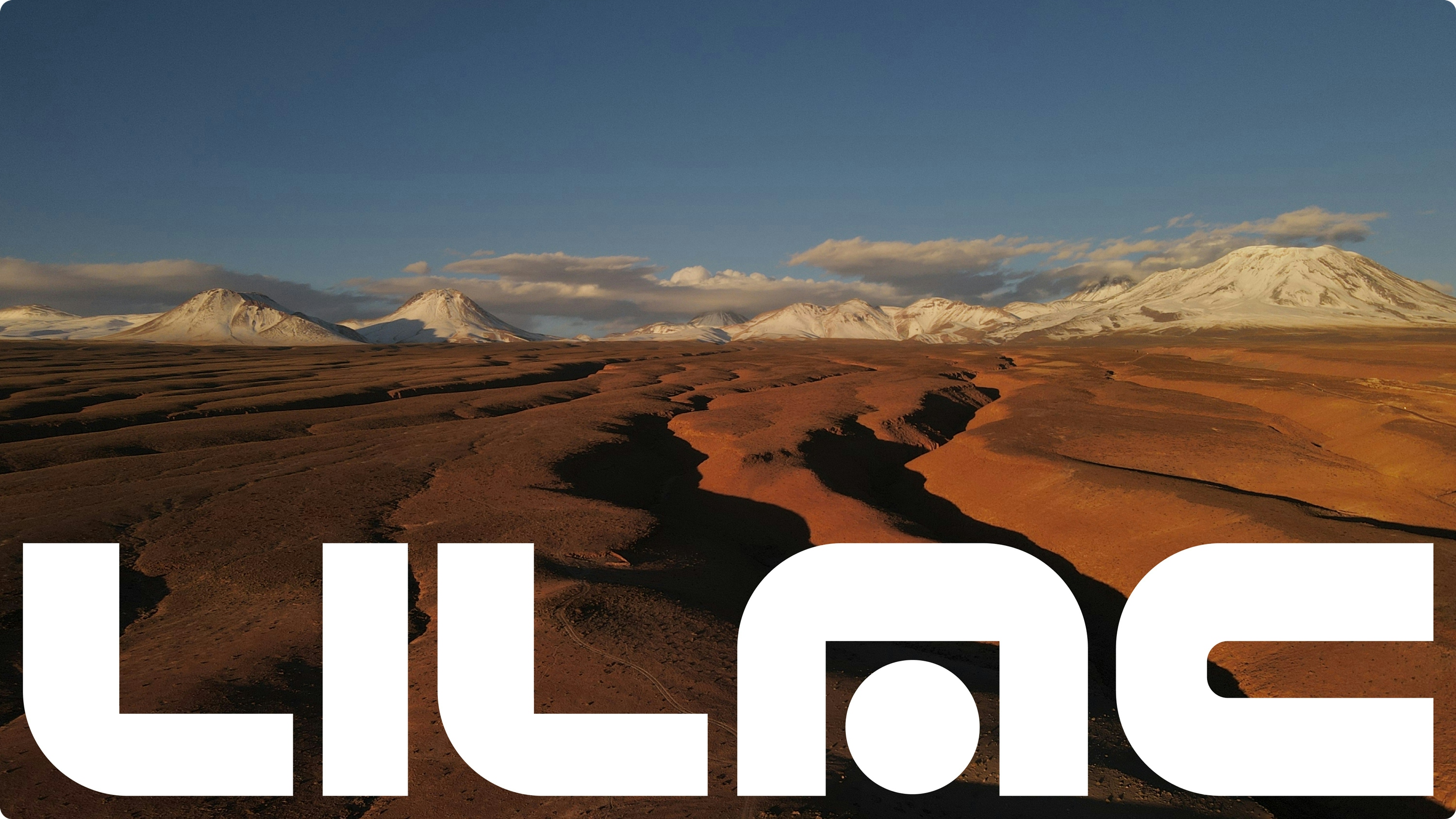 Lilac wordmark superimposed over a dramatic desert landscape image